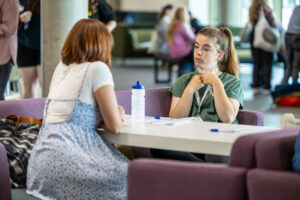 A youth worker receives some advice in a desk-based conversation