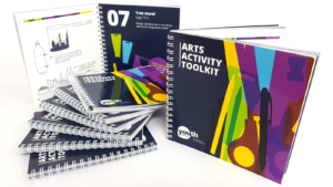 A collection of spiral wire-bound toolkits are arranged on display.
