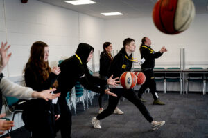 A class of young people enjoy basketball games