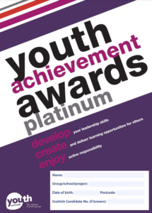 A close up of the Youth Achievement Awards Platinum booklet in purple.