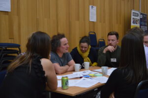 Youth Scotland members sit a table for a discussion