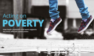 The front cover of Youth Scotland's report: Acting on Poverty. A young person's feet can be seen jumping above a puddle of water.