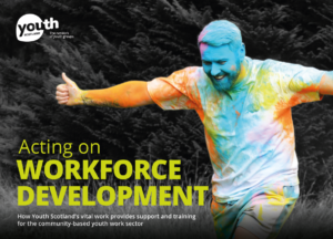 Yellow text reads, 'Acting on Workforce Development.' Below, white text reads, 'How Youth Scotland's vital work provides support and training for the community-based youth work sector. In the background, a youth worker participates in a colour run. In the upper left corner, the Youth Scotland logo sits in white.