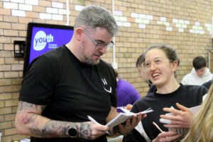 Two youth workers compare notes during training