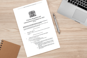 A document lies on a table with the headline 'Charities (Regulation and Administration) (Scotland) Act 2023'