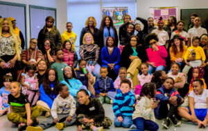 Young people, youth workers and parents from Touch of Love smile for the camera at a cultural event