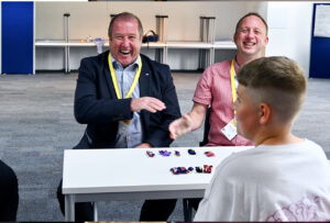 Mr Dey MSP and Mike Strang shake hands after solving a puzzle