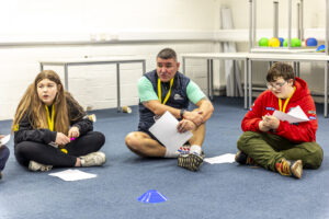 A Youth Scotland youth worker facilitates a reflective game for young people