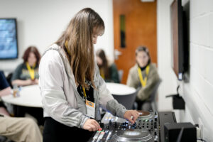 Alona tries using DJ and mixing decks in a workshop