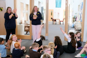 The BEE youth work team celebrate their National Youth Work Award with the younger children